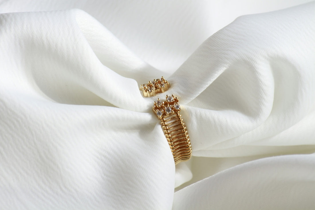 A close up of a white cloth with a gold ring on it