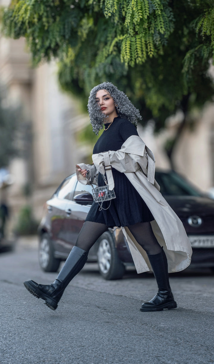 Woman with curly gray hair walking on street